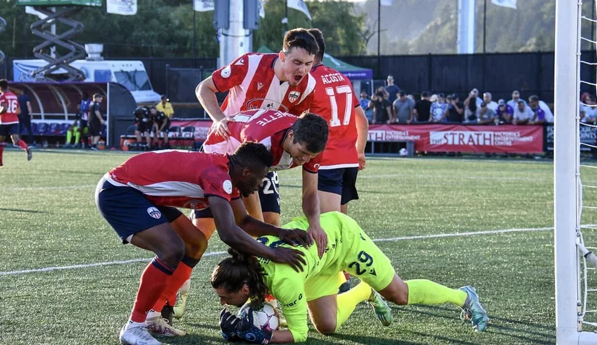 Players contesting near the goal during match Players contesting near the goal during match