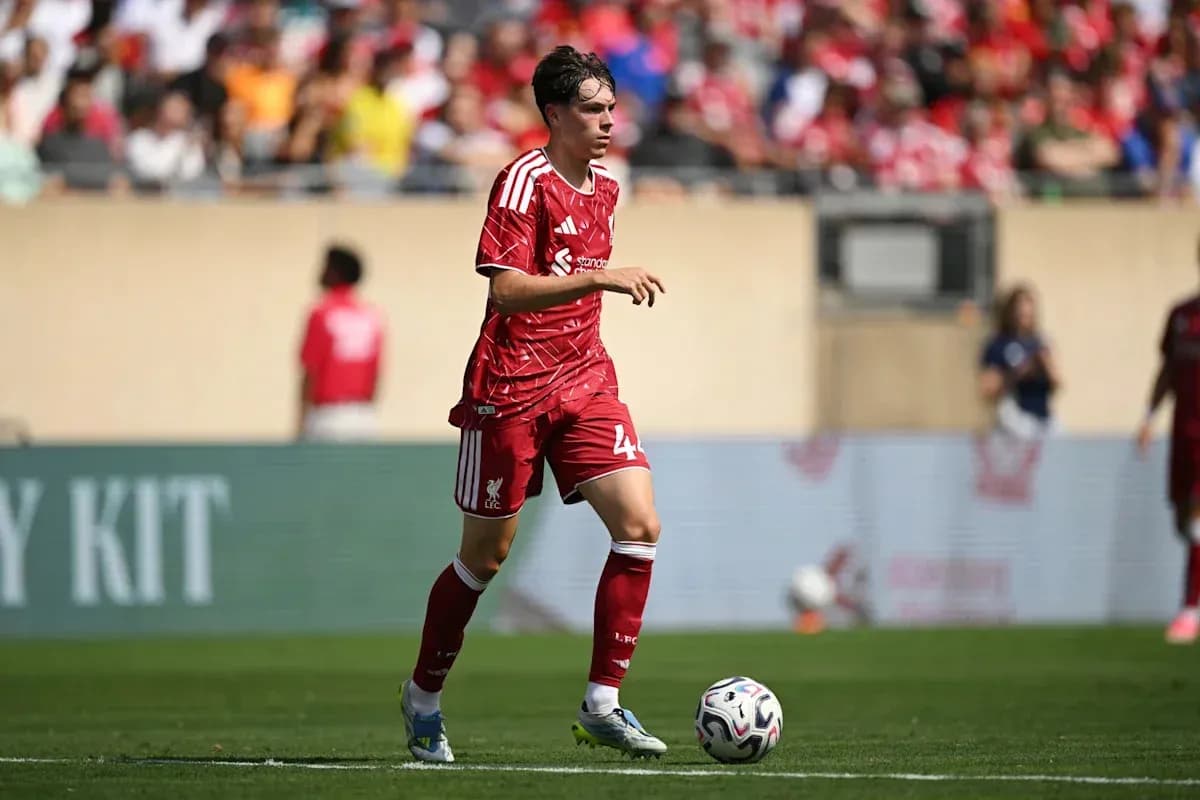 Player in red Liverpool kit running with ball Player in red Liverpool kit running with ball