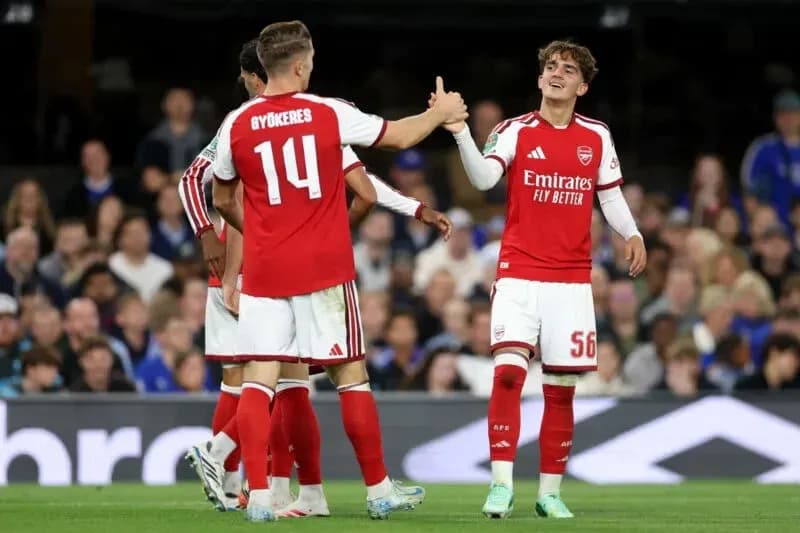 Arsenal players celebrating on the field during match Arsenal players celebrating on the field during match