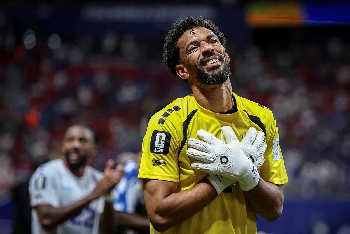 Goalkeeper celebrating with gloves raised in victory Goalkeeper celebrating with gloves raised in victory