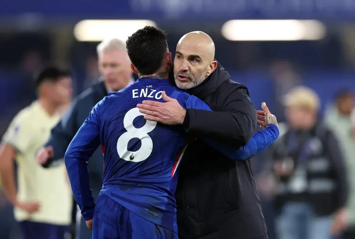 Player embracing coach after match on the field Player embracing coach after match on the field