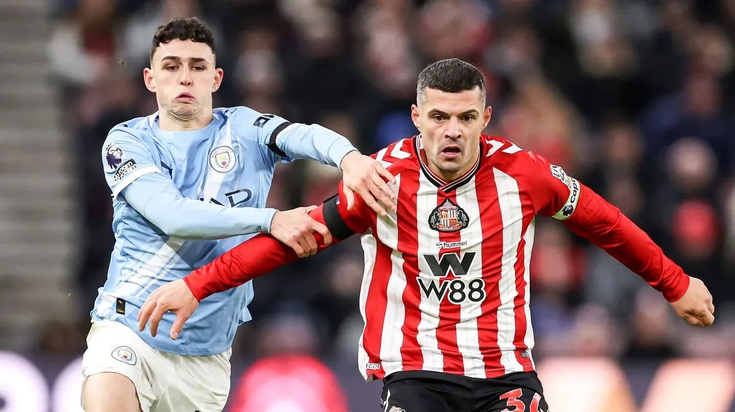 Manchester City player tackling Sunderland opponent Manchester City player tackling Sunderland opponent