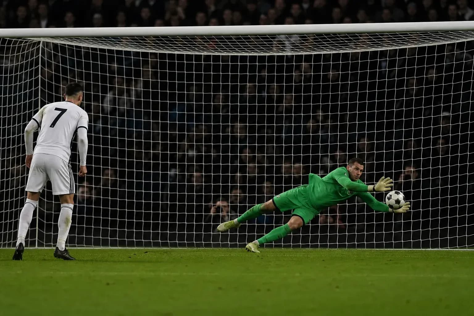 Goalkeeper diving to save a penalty kick Goalkeeper diving to save a penalty kick