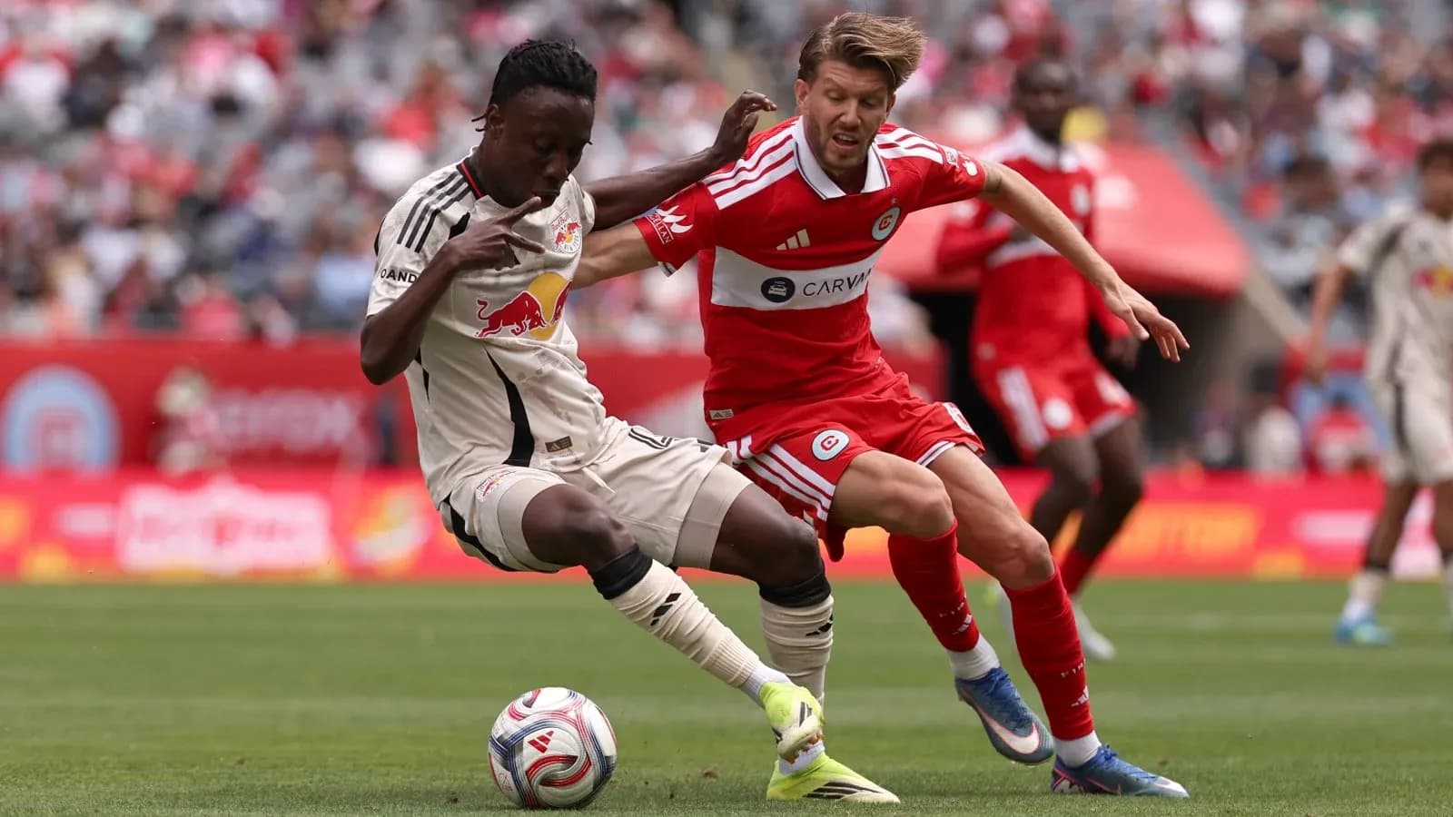 New York Red Bulls player tackles Chicago Fire opponent New York Red Bulls player tackles Chicago Fire opponent