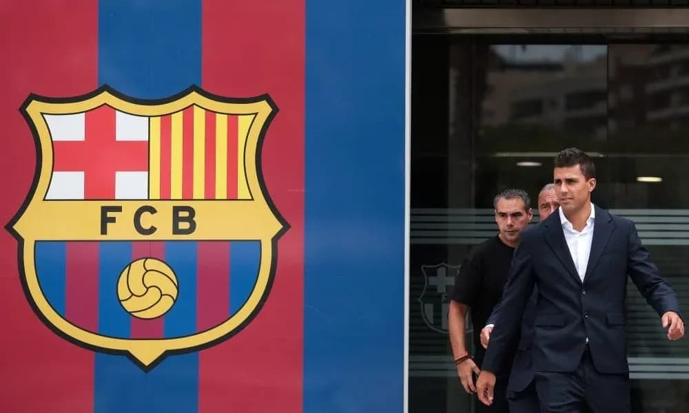 Player exiting building beside FC Barcelona logo Player exiting building beside FC Barcelona logo