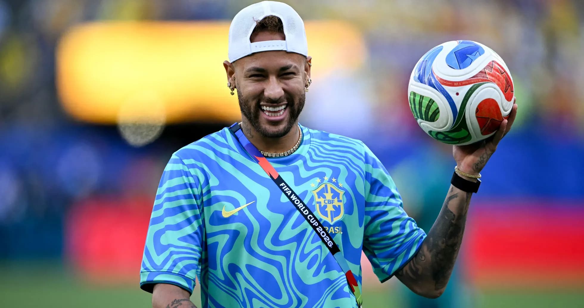 Player holding a soccer ball, smiling on field Player holding a soccer ball, smiling on field