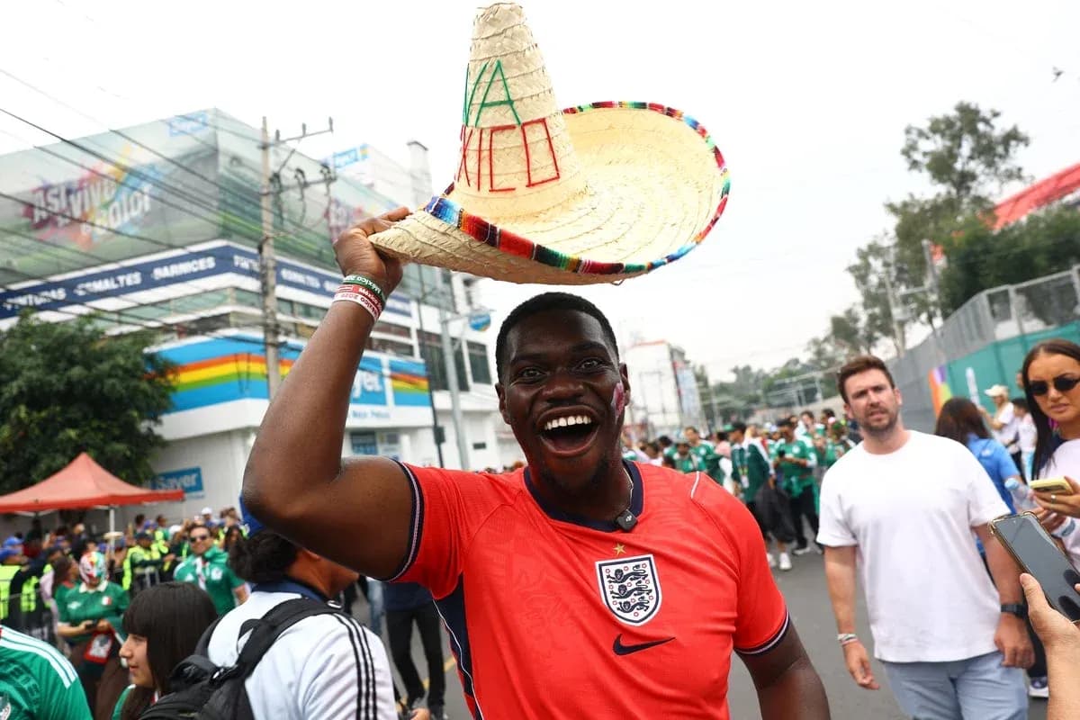 Fan wearing England jersey and sombrero at event Fan wearing England jersey and sombrero at event