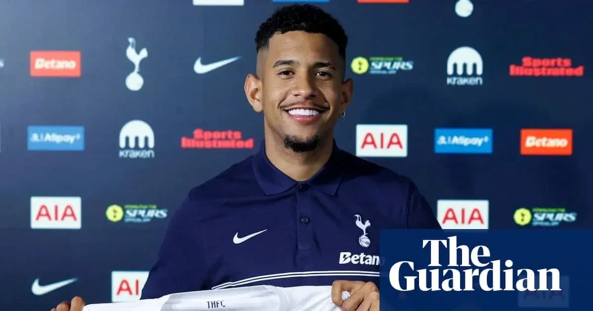 Player holding Tottenham Hotspur jersey at press conference Player holding Tottenham Hotspur jersey at press conference