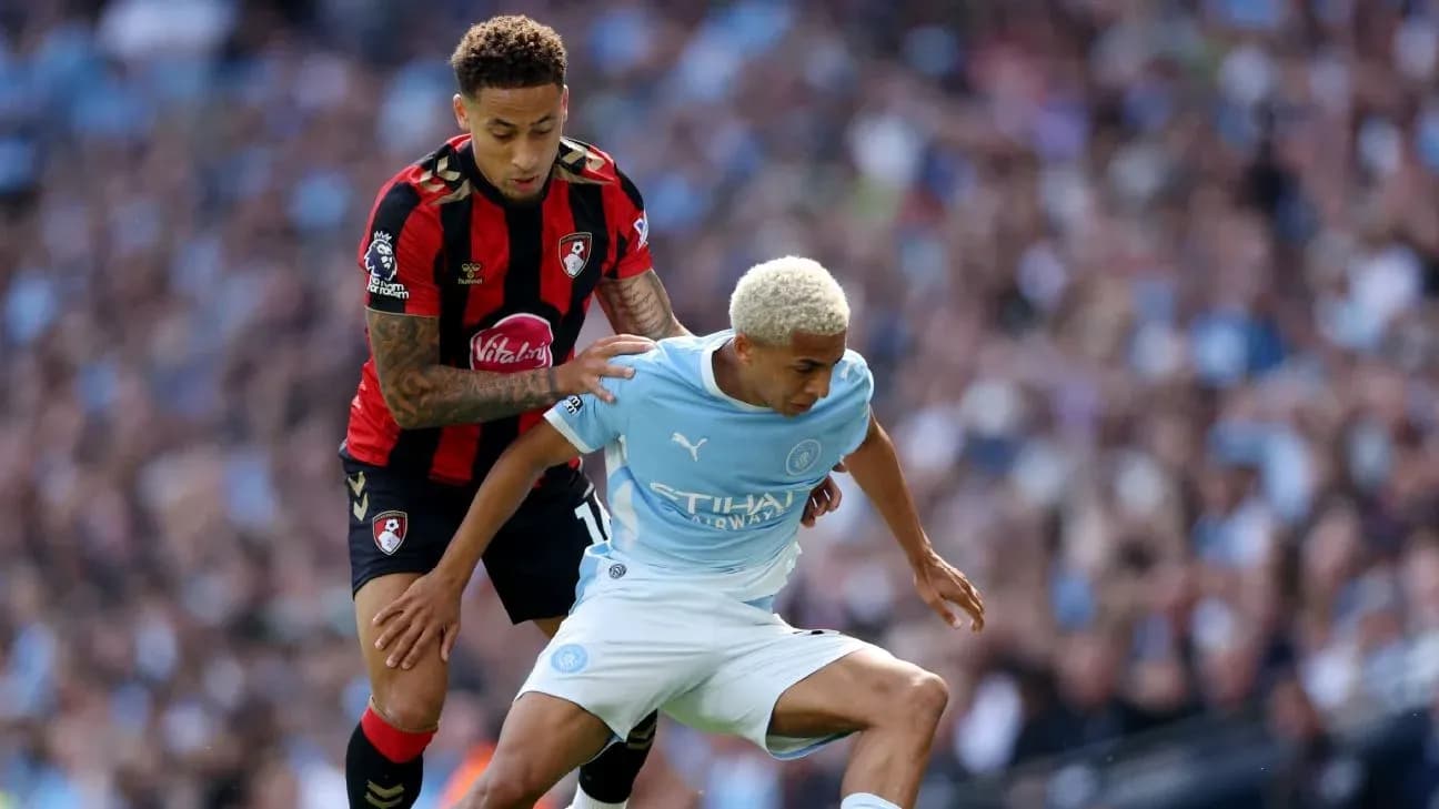 Bournemouth player tackles Manchester City player during match Bournemouth player tackles Manchester City player during match
