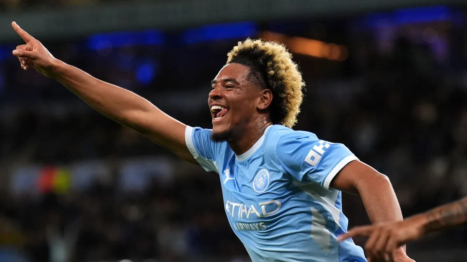 Player celebrating a goal with outstretched arm Player celebrating a goal with outstretched arm