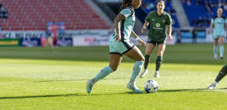 Player dribbling the ball during NWSL match Player dribbling the ball during NWSL match