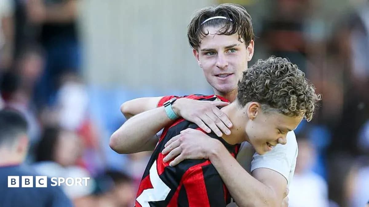 Two football players embracing after a match Two football players embracing after a match