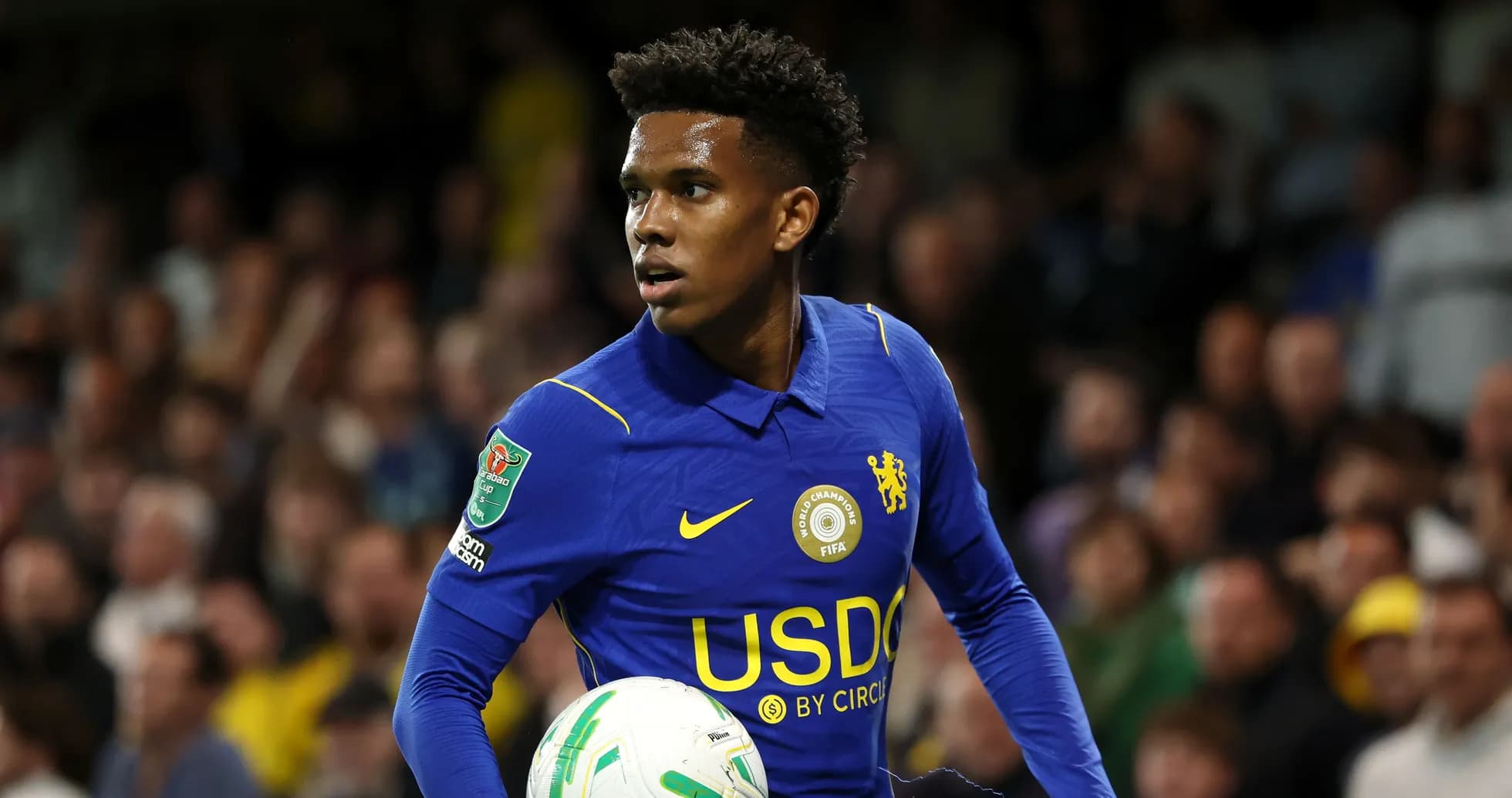 Player in blue jersey holding football during match Player in blue jersey holding football during match