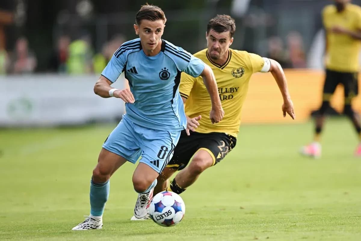 Player sprinting with ball during football match Player sprinting with ball during football match