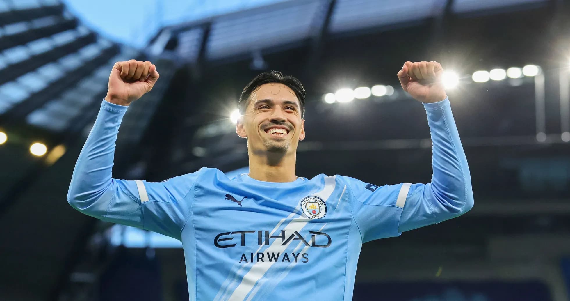 Player celebrating victory in Manchester City jersey Player celebrating victory in Manchester City jersey