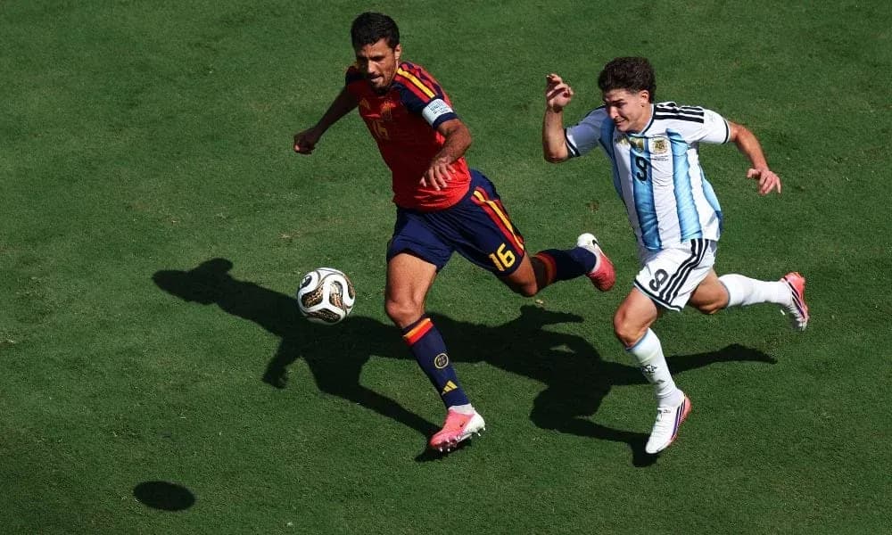 Two players competing for the ball in match Two players competing for the ball in match