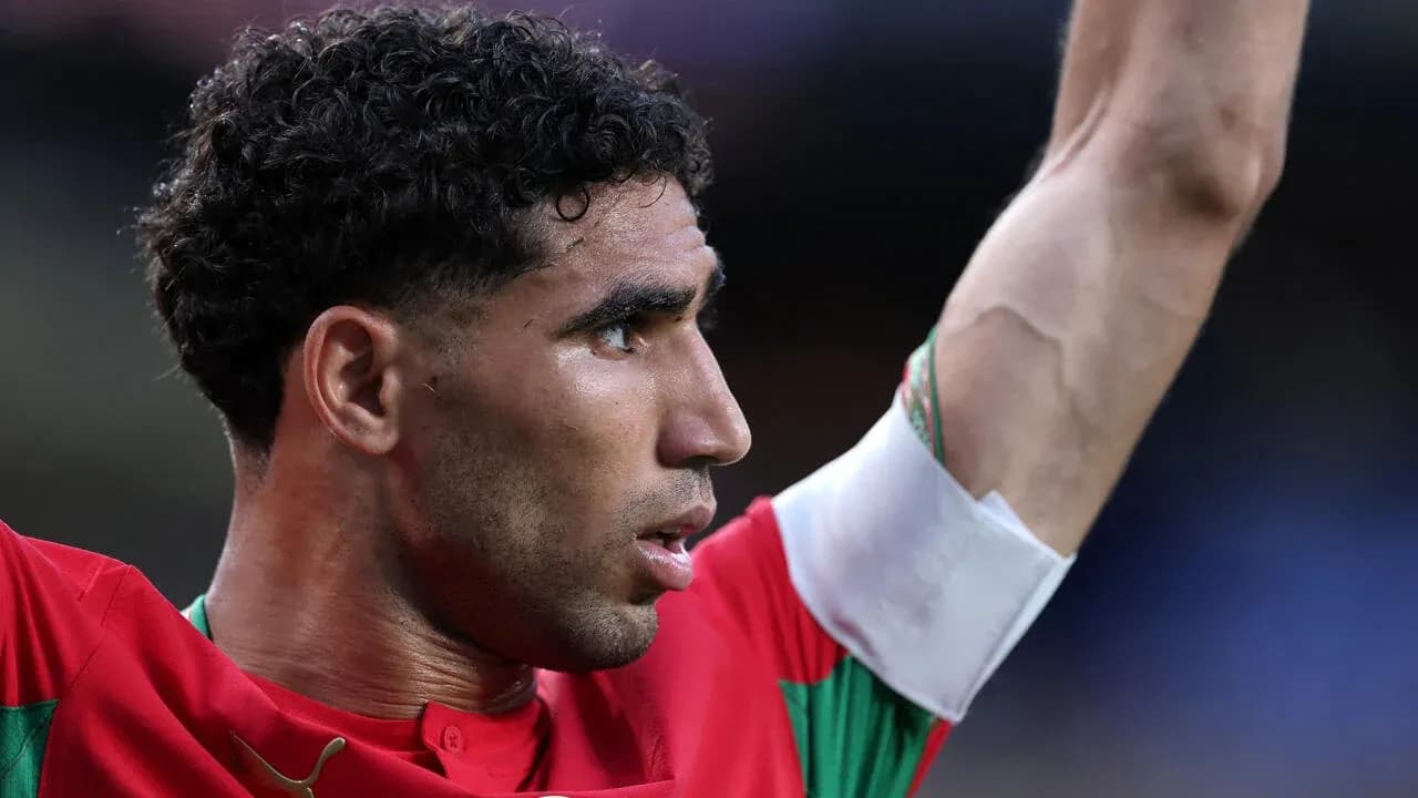 Player celebrating with raised arm in red jersey Player celebrating with raised arm in red jersey