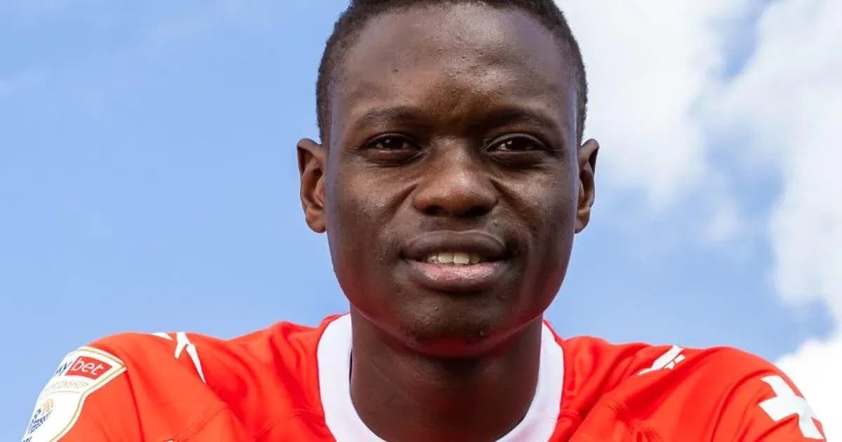 Player wearing red jersey against blue sky background Player wearing red jersey against blue sky background