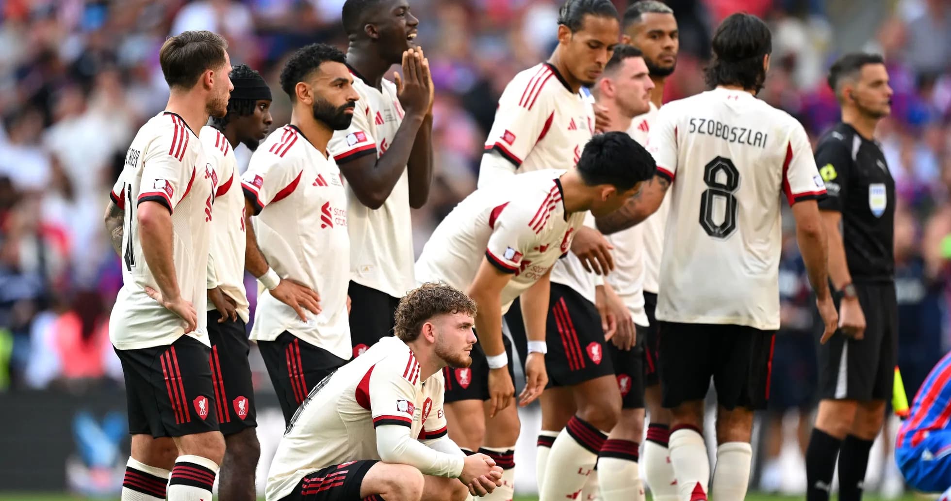 Players in white jerseys preparing for a free kick Players in white jerseys preparing for a free kick