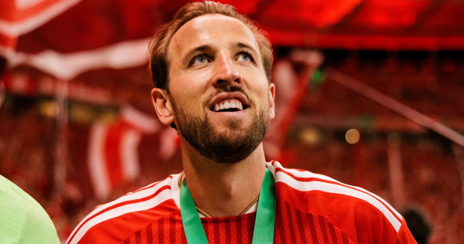 Player wearing red jersey celebrating with medal Player wearing red jersey celebrating with medal