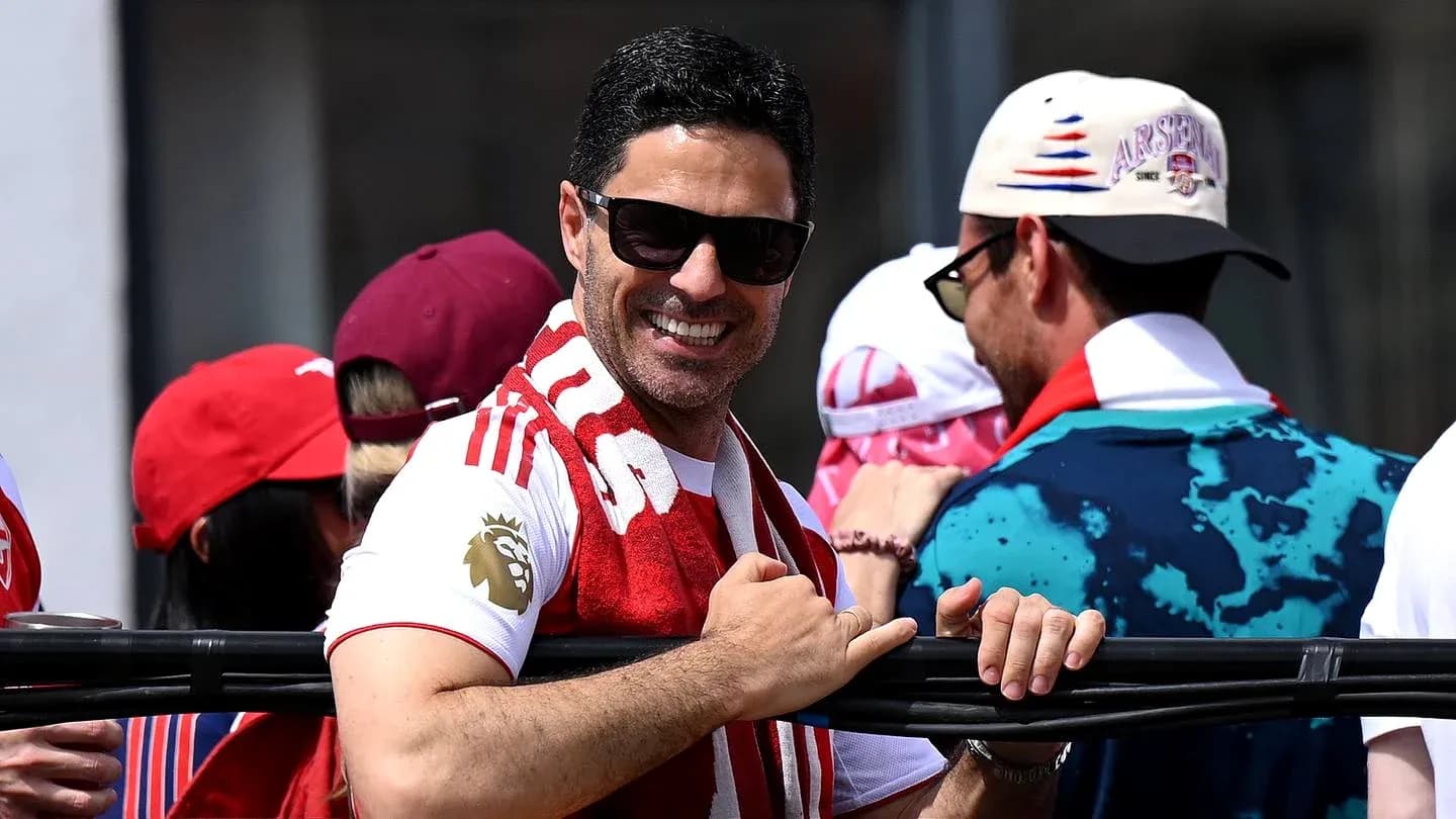 Fan smiling with Arsenal scarf at event Fan smiling with Arsenal scarf at event