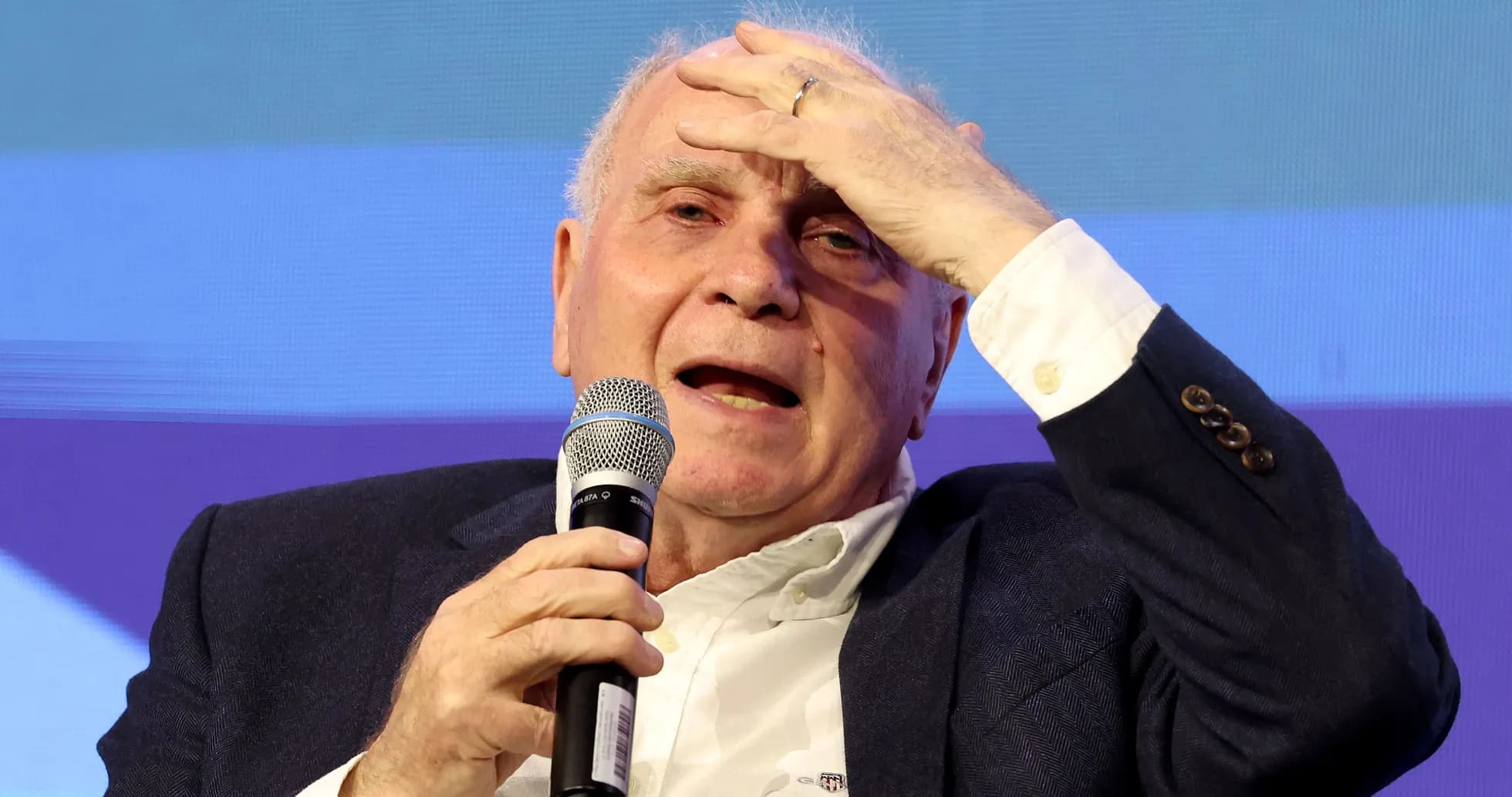 Man speaking into a microphone during event Man speaking into a microphone during event