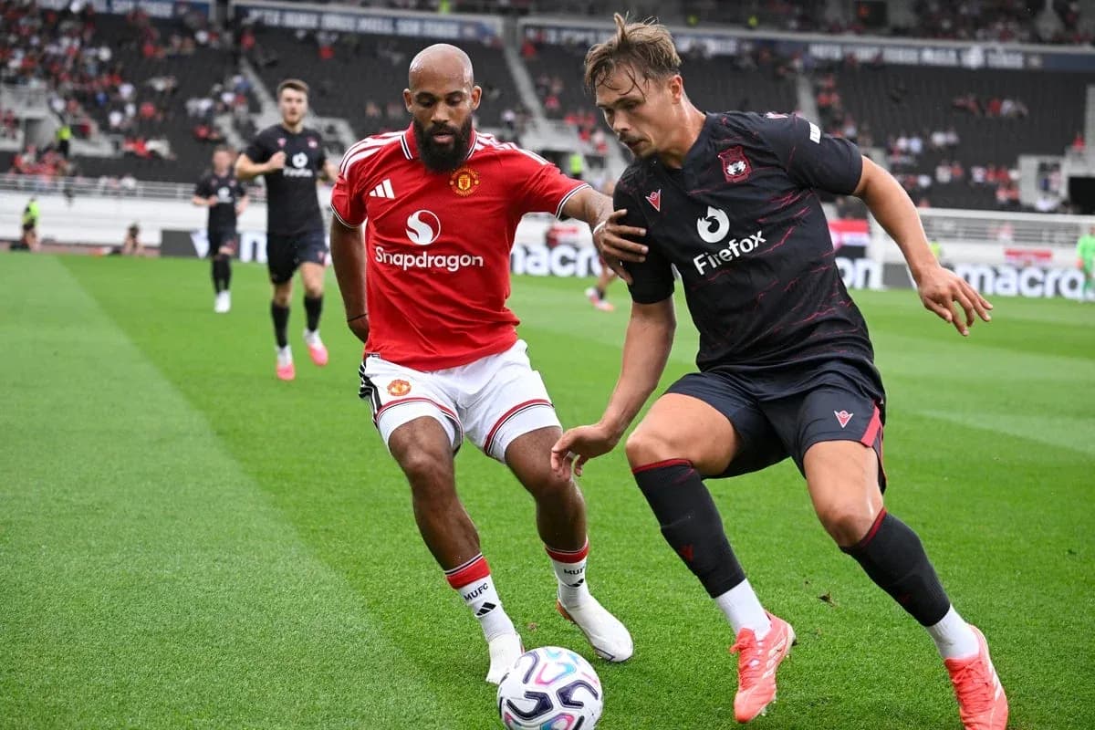 Two players contesting for the ball during match Two players contesting for the ball during match