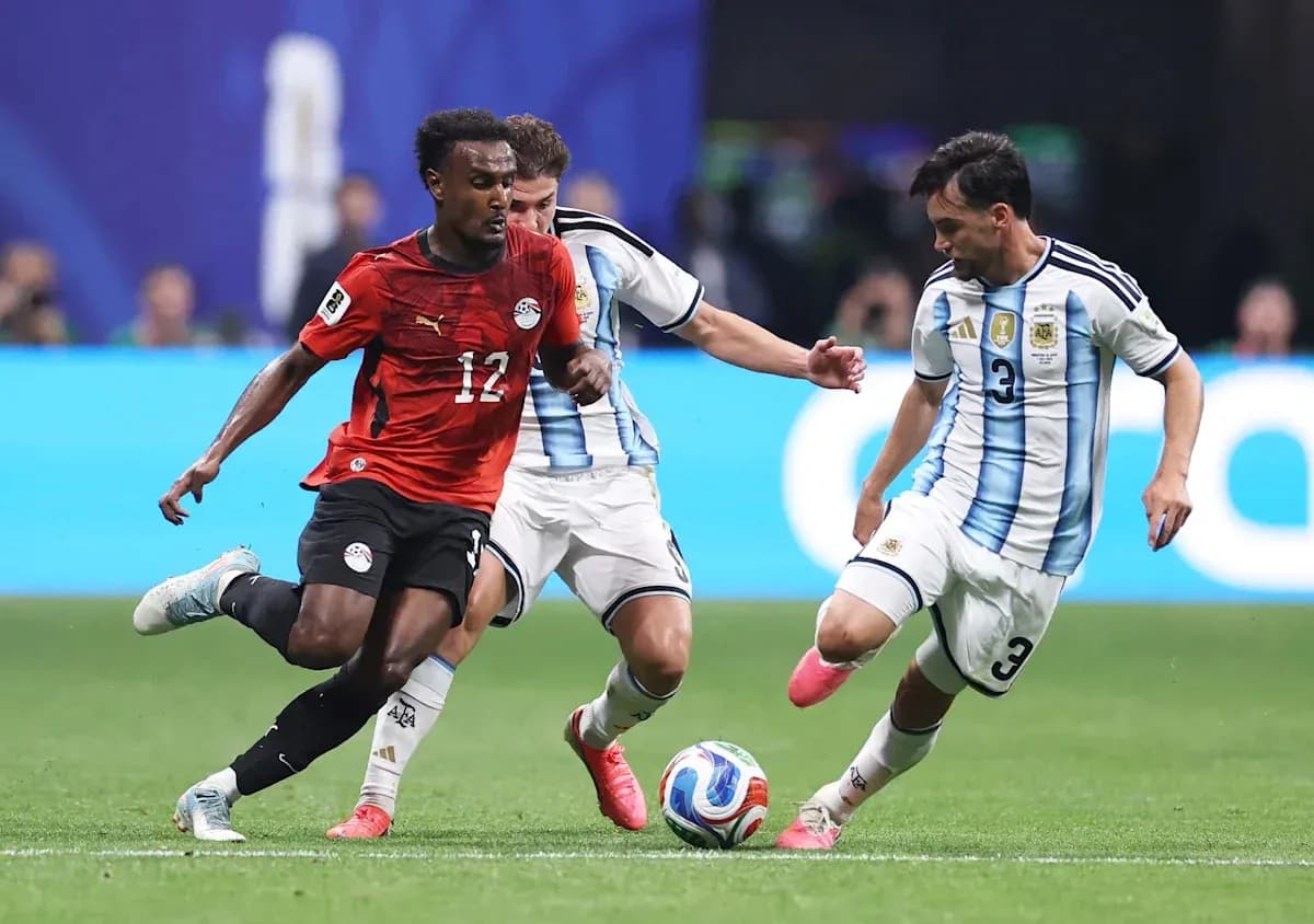Egyptian player dribbling past Argentine defenders Egyptian player dribbling past Argentine defenders