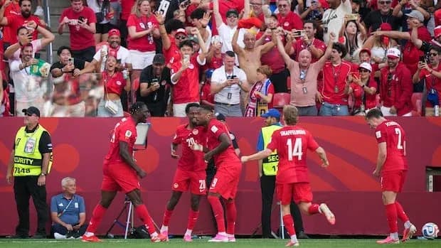 Players celebrating a goal with fans in stadium Players celebrating a goal with fans in stadium