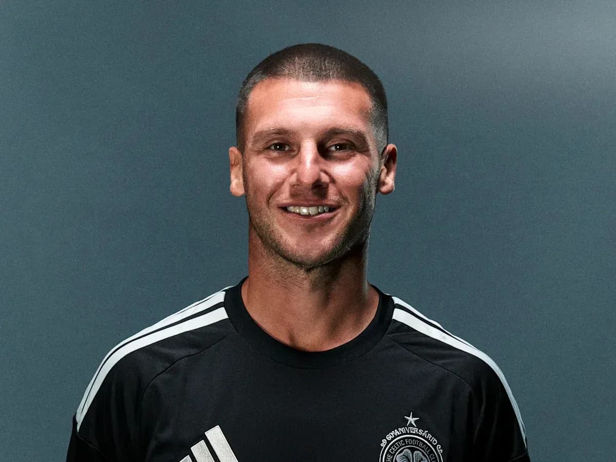 Player posing in black training kit with logo Player posing in black training kit with logo
