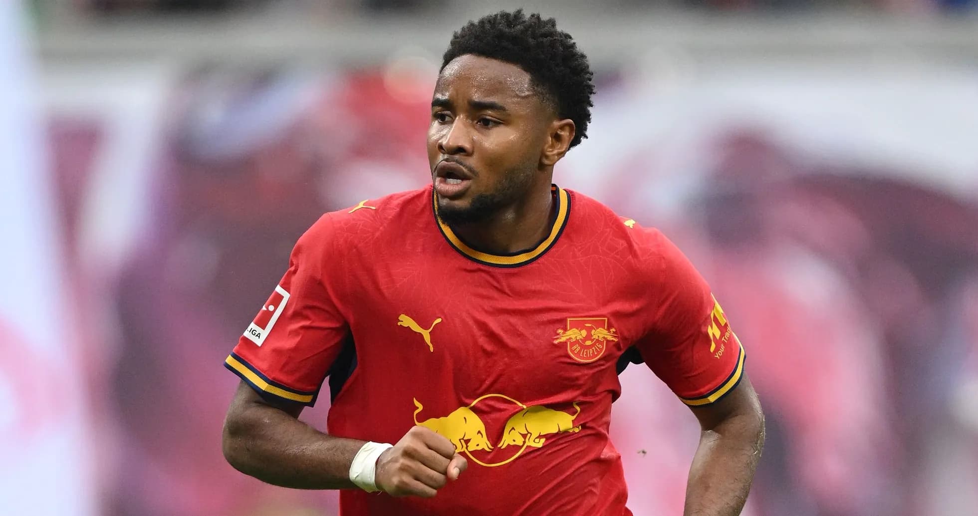 Player running in RB Leipzig's red home jersey Player running in RB Leipzig's red home jersey