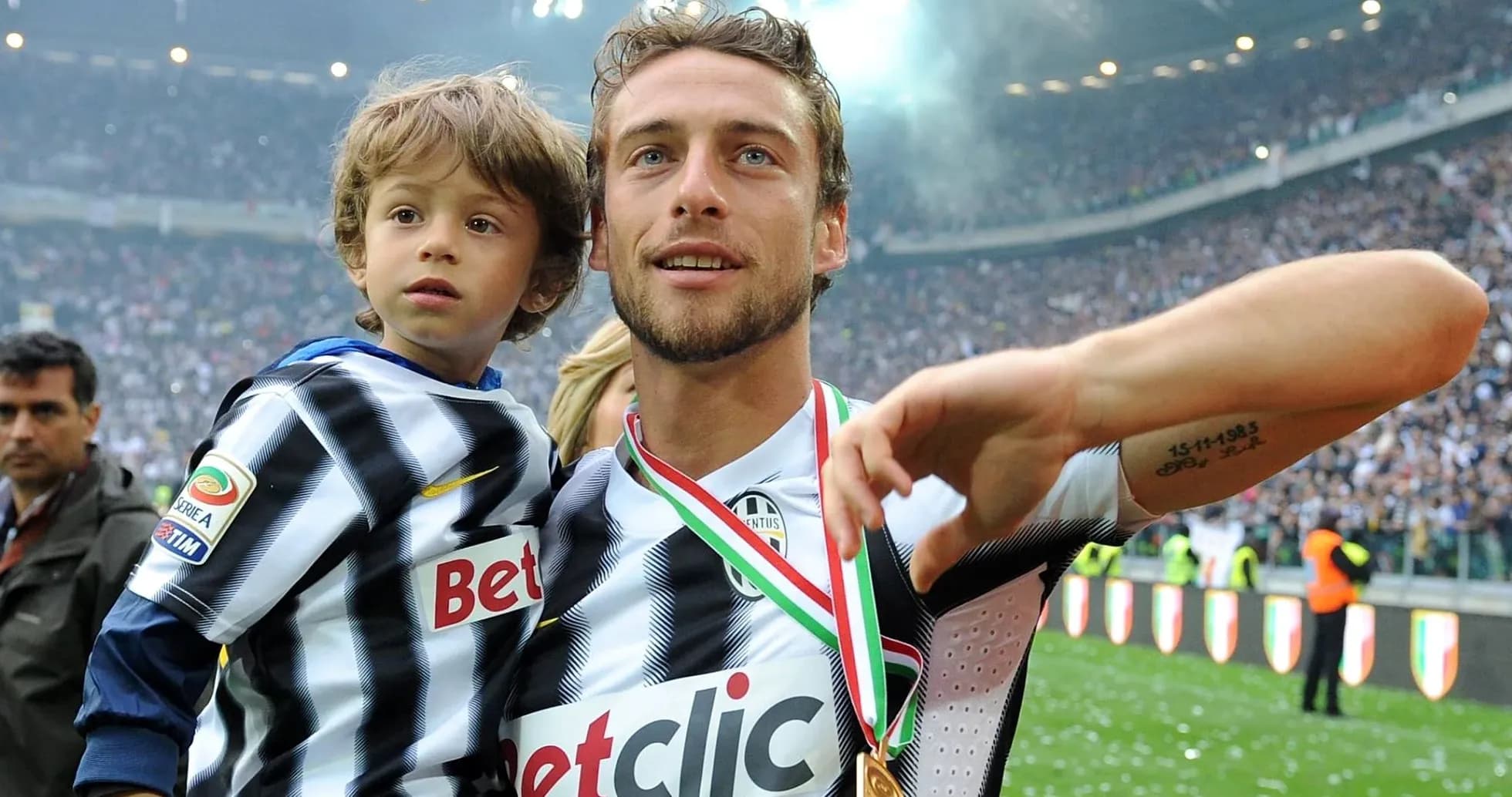 Player celebrating with child after match victory Player celebrating with child after match victory
