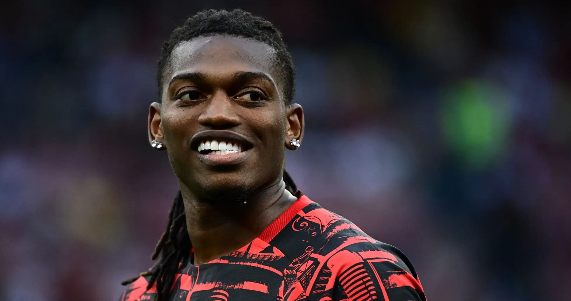 Player smiling in red and black sports jersey Player smiling in red and black sports jersey
