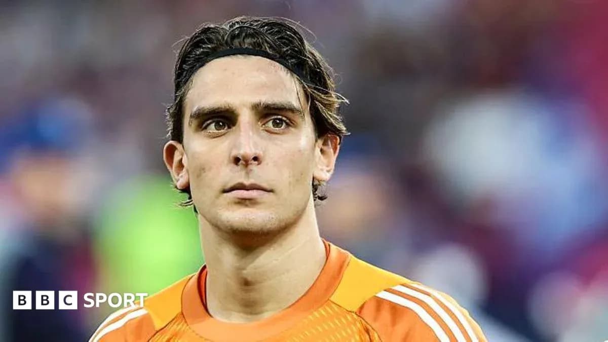 Goalkeeper in orange kit looking at the camera Goalkeeper in orange kit looking at the camera