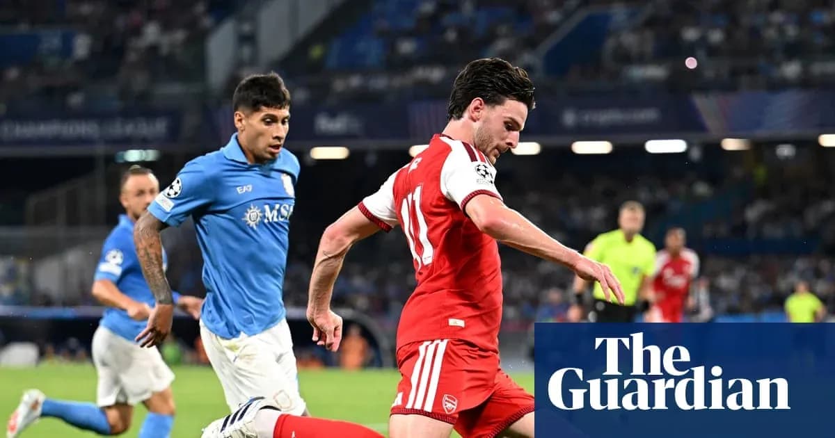 Player in red dribbling past opponent in blue Player in red dribbling past opponent in blue