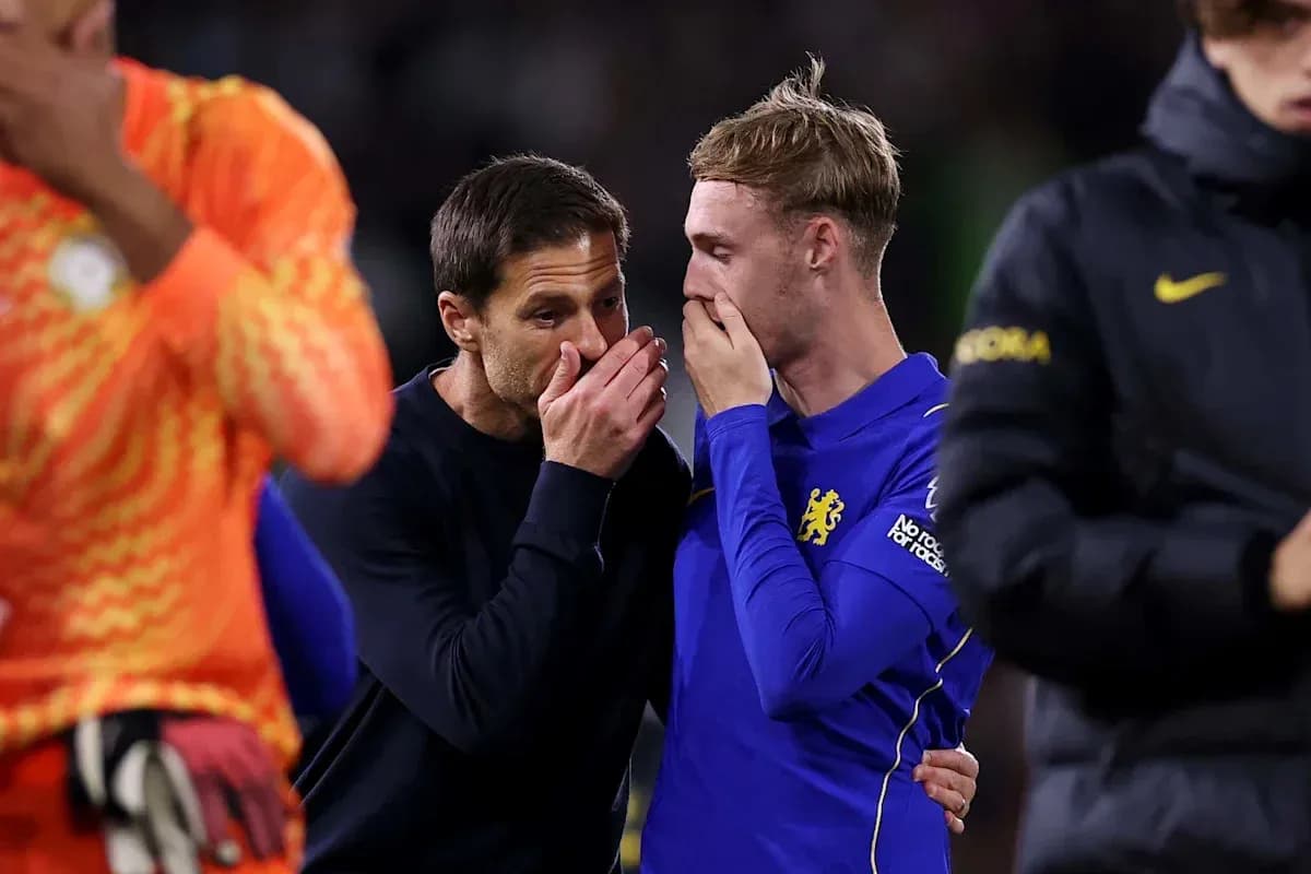Coach and player discussing on the pitch after match Coach and player discussing on the pitch after match