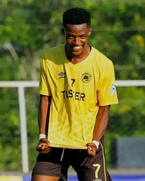 Player celebrating in yellow jersey after scoring Player celebrating in yellow jersey after scoring