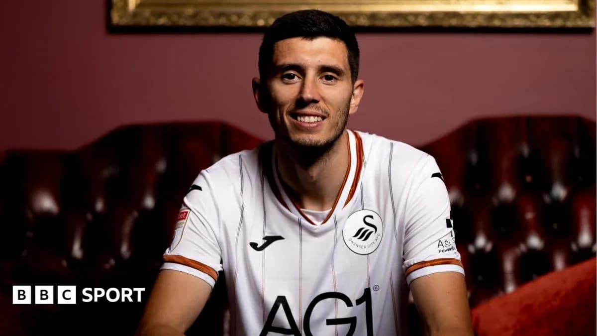 Player in Swansea City jersey sitting on couch Player in Swansea City jersey sitting on couch