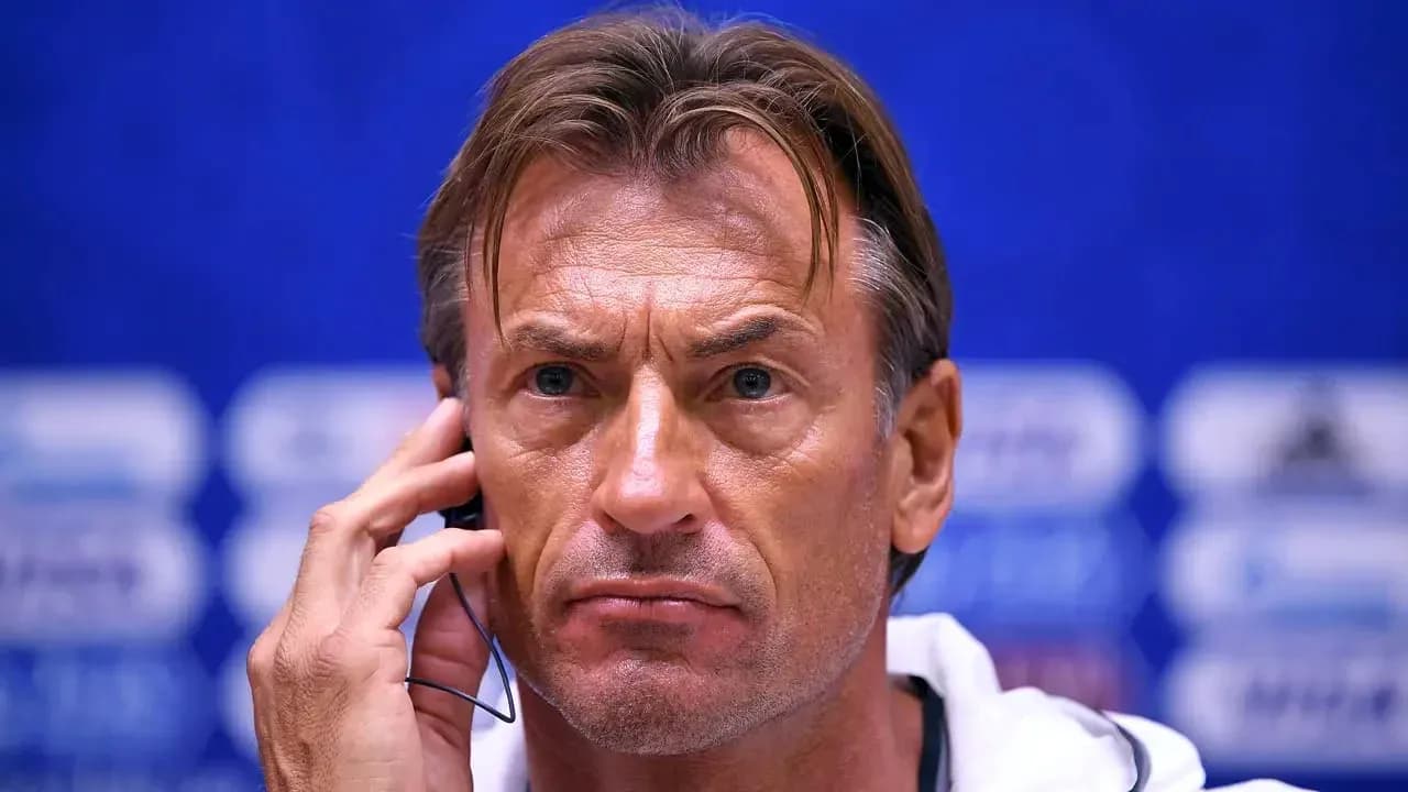 Coach listening during a press conference Coach listening during a press conference