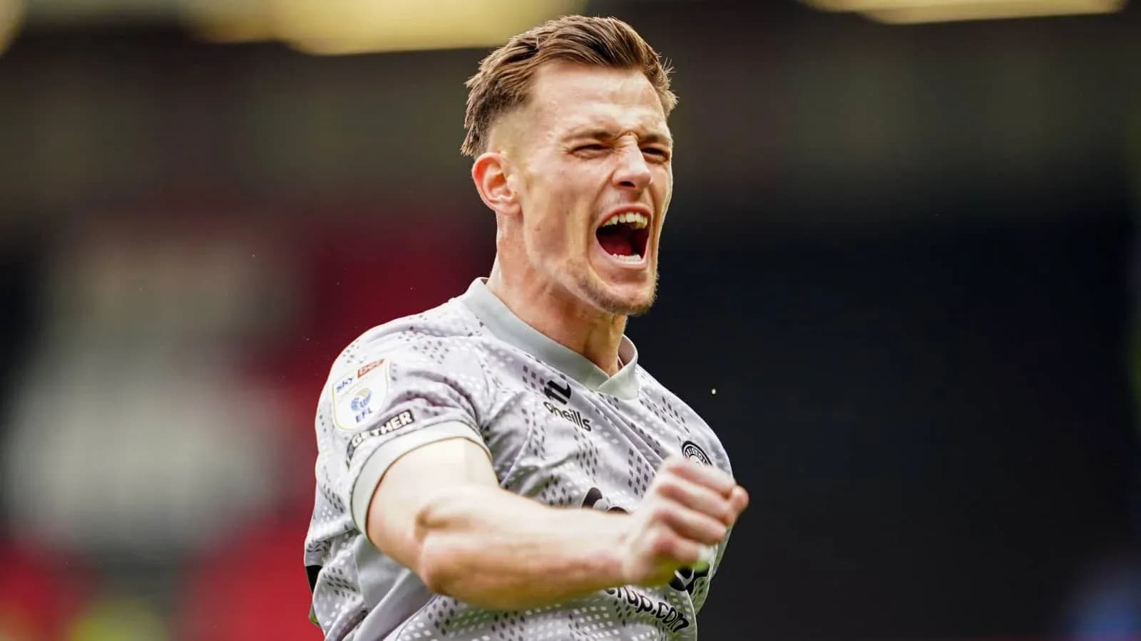 Player celebrating a goal with raised fists Player celebrating a goal with raised fists
