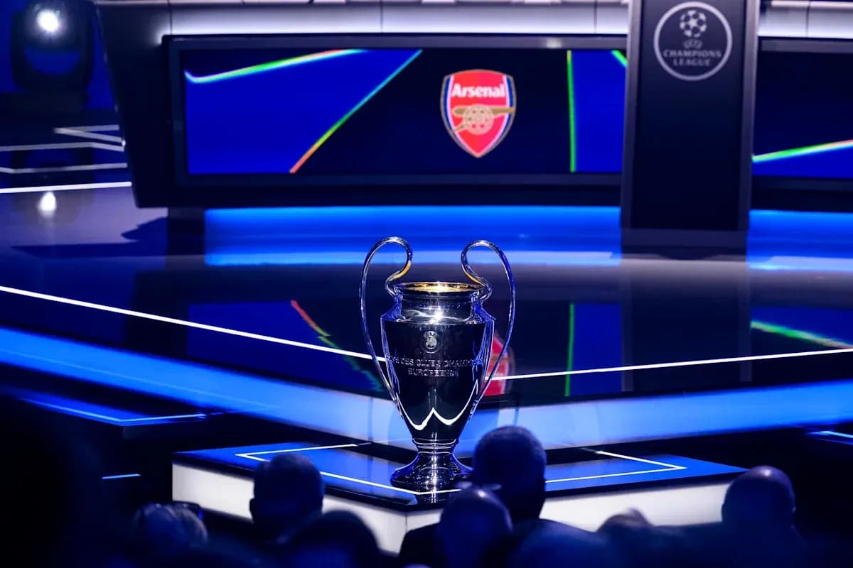Champions League trophy on stage with Arsenal logo Champions League trophy on stage with Arsenal logo