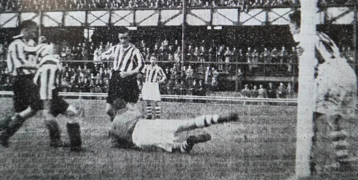 Players contesting a ball near the goalpost Players contesting a ball near the goalpost
