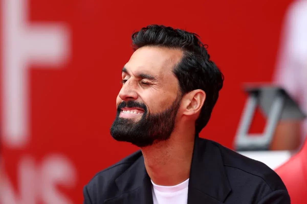 Man smiling and winking in front of red background Man smiling and winking in front of red background