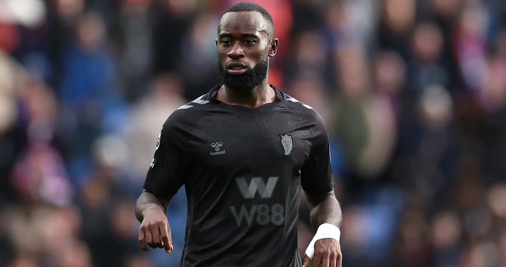 Player in black kit during a match Player in black kit during a match