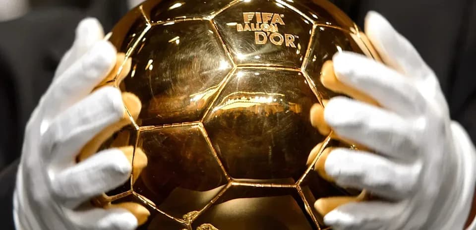 Person holding the FIFA Ballon d'Or trophy Person holding the FIFA Ballon d'Or trophy
