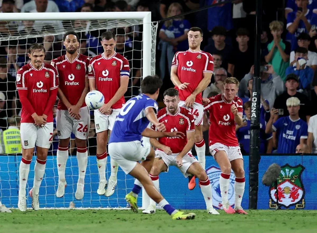 Player taking free kick against wall of defenders Player taking free kick against wall of defenders
