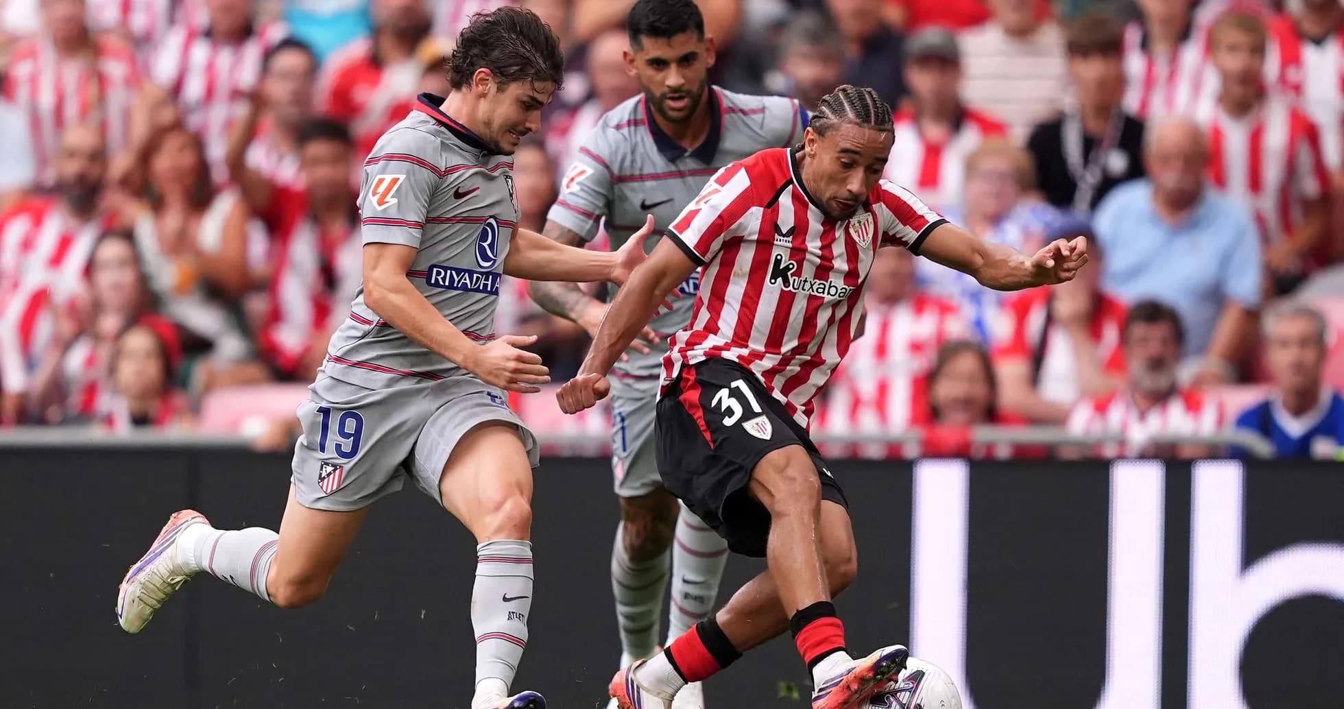 Athletic Club player dribbling past Atletico Madrid defenders Athletic Club player dribbling past Atletico Madrid defenders