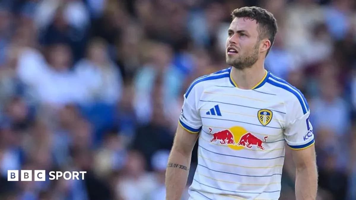 Leeds United player during match with fans in background Leeds United player during match with fans in background