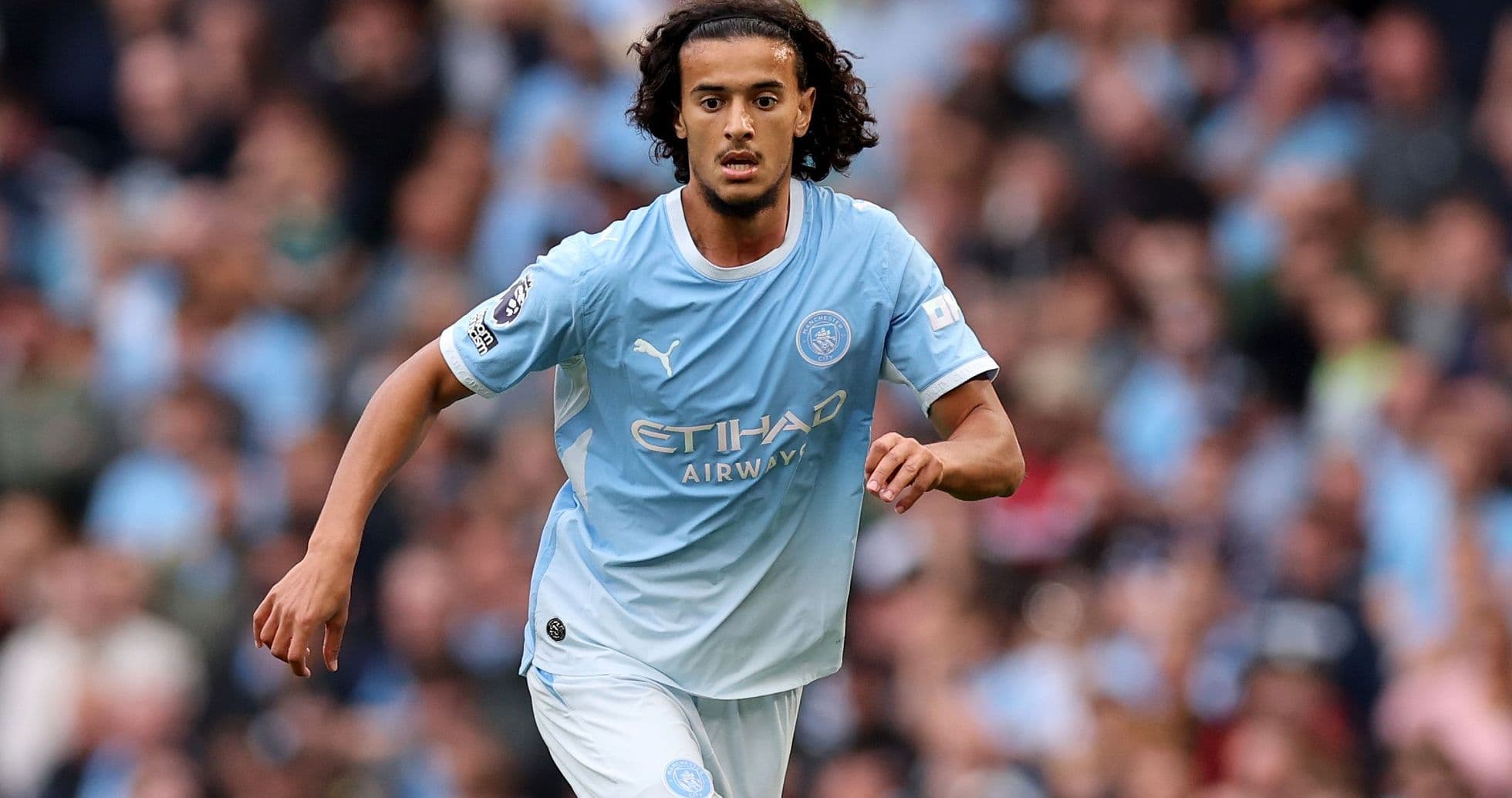 Player running on the pitch in Manchester City kit Player running on the pitch in Manchester City kit