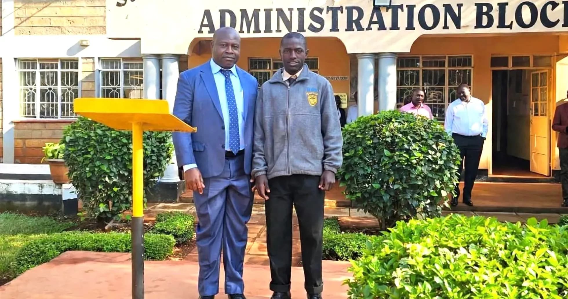 Two men posing outside St. Anthony's Boys' High School Two men posing outside St. Anthony's Boys' High School